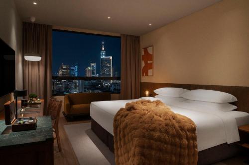 a hotel room with a bed and a view of a city at HYATT - EPISODE Daan Taipei, jdv by Hyatt in Taipei