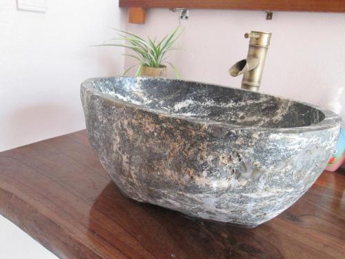 a silver sink on a wooden counter with a faucet at Ninh Binh Nature Homestay in Ninh Binh