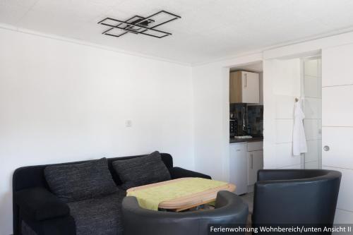 a living room with a couch and two chairs at Ferienwohnung in Bodden & Ostsee nähe in Sagard