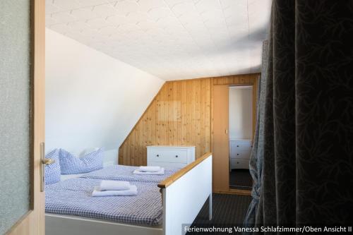 a bedroom with two beds in a attic at Ferienwohnung in Bodden & Ostsee nähe in Sagard