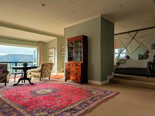 a room with a table and a bedroom with a bed at Camp Figtree by The Oyster Collection in Addo
