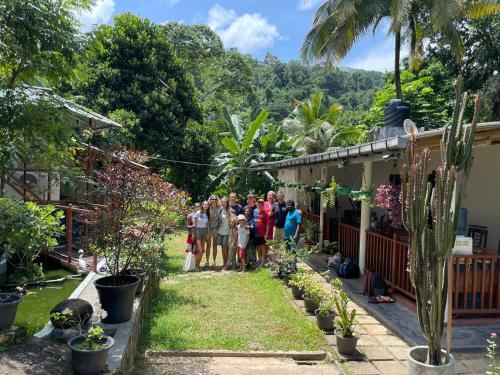 a group of people standing outside of a house at Kandy Food Lovers Home Stay by AGS in Kandy