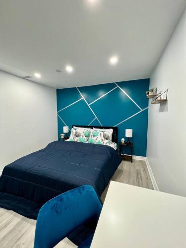 a bedroom with a large bed and a blue wall at Private Room Near Airport K8 in Mississauga