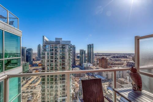 a view of a city from the balcony of a building at Cozy 2BR Condo with King Bed and City Views in Calgary