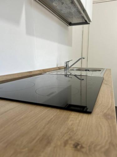 a glass table on a wooden floor in a room at Villa Stella Marina in Porto Cesareo