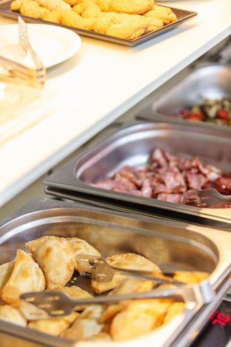 un buffet con diferentes tipos de comida en bandejas en Steris Elegant Beach Hotel, en Rethymno