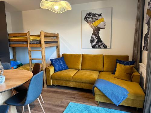 a living room with a couch and a bunk bed at Angel Wings Mountain Apartment Černý Důl in Cerny Dul