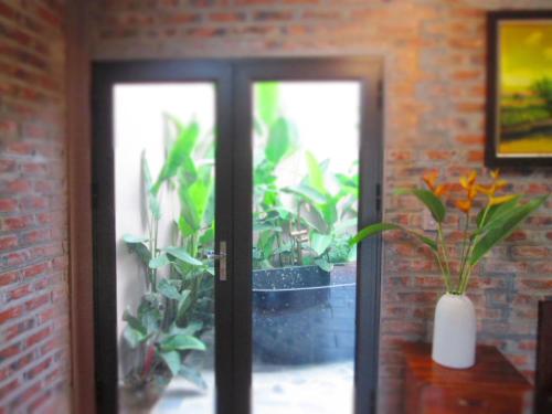 a door with a bunch of plants in a room at Ninh Binh Nature Homestay in Ninh Binh