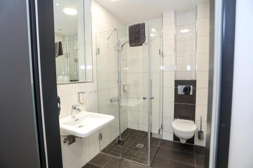 a bathroom with a sink and a toilet at Sportschule Wedau in Duisburg