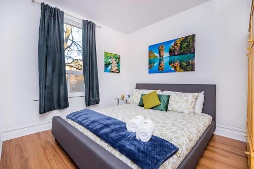 a bedroom with a bed with two towels on it at Pet-friendly Apartment - Steps to Rideau Centre in Ottawa