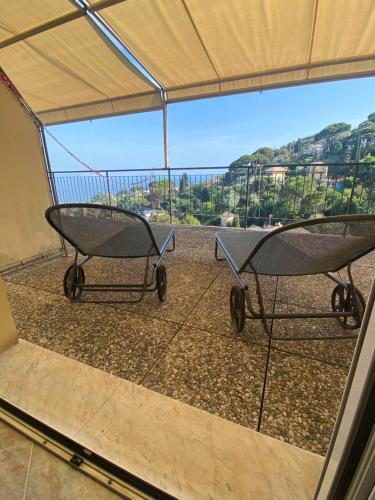two chairs under a tent with a view at Hotel Primo Sole in Rapallo