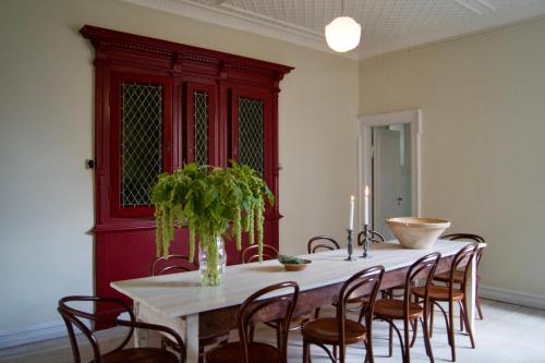 a dining room with a table with chairs and candles at SJ Apartment in Aarhus