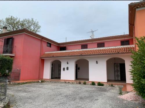 a red and white house with a driveway at Casa Luciana in Santa Maria del Molise