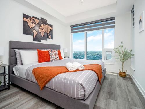 a bedroom with a bed and a large window at Modern 1BR Condo - King bed - Cityscape Views in Kitchener