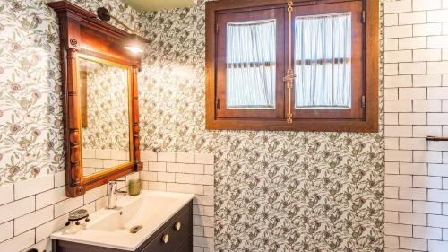 a bathroom with a sink and a mirror at Casa Huerta de la Fuente Hornachuelos by Ruralidays in Hornachuelos