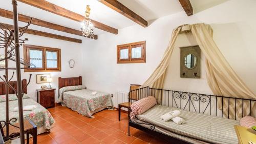 a bedroom in a villa with two beds at Casa Huerta de la Fuente Hornachuelos by Ruralidays in Hornachuelos