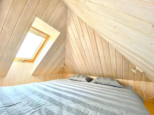 a bedroom with a bed in a attic at Japandi Guesthouse in Muhu in Võiküla