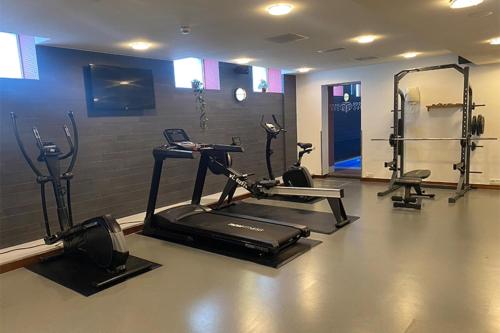 a gym with a treadmill and elliptical machines at Grand Hotel Amrâth Amsterdam in Amsterdam