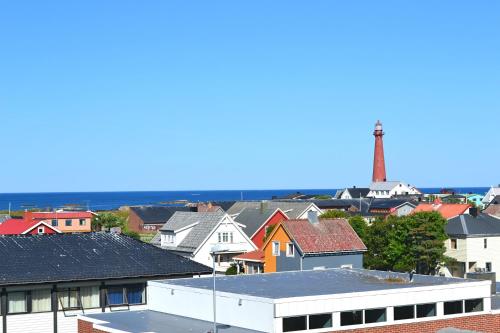 a view of a city with a lighthouse in the background at Andenes Suitehotel in Andenes