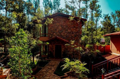 a brick house in the middle of a forest at Sereno Barn Eco Stay Chikmagalur in Chikmagalūr