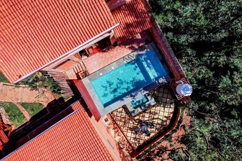 an overhead view of a swimming pool in a house at Sereno Barn Eco Stay Chikmagalur in Chikmagalūr