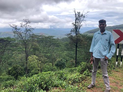 a man standing on top of a hill at Kandy Food Lovers Home Stay by AGS in Kandy