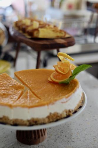 a table topped with a cake with orange toppings at Hotel Albatros in Rimini