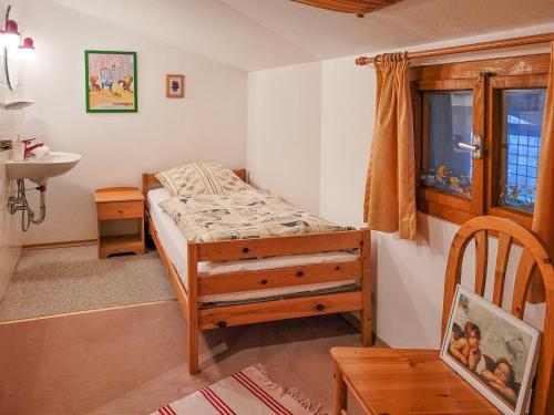 a small bedroom with a bed and a sink at Ferienwohnung Haus Rosenbichl GbR in Schönau am Königssee