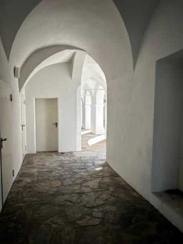 an empty hallway with white walls and an archway at Schloss Apartment Lankowitz in Maria Lankowitz