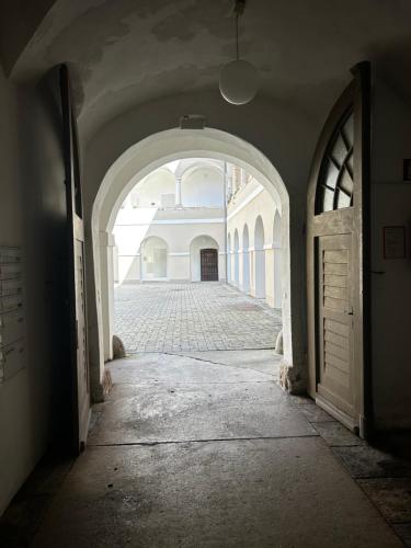 an empty hallway with an archway in a building at Schloss Apartment Lankowitz in Maria Lankowitz