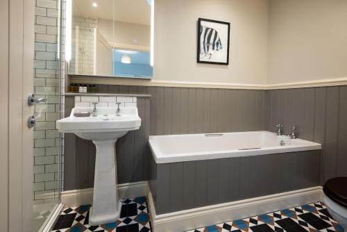a bathroom with a sink and a bath tub at Farm Cottage in Berwick-Upon-Tweed