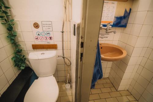 a bathroom with a toilet and a sink at Hostel KlonDike in Pec pod Sněžkou