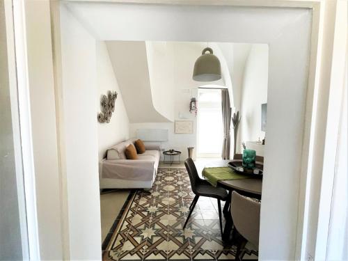 a living room with a table and a couch at Suite Sami Charming Home in Ostuni