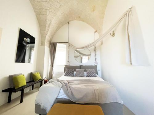 a bedroom with a bed in a room at Suite Sami Charming Home in Ostuni