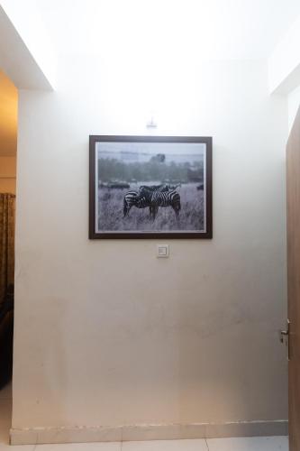 a picture of two zebras on a wall at The Lake Palm Hotel in Kolkata
