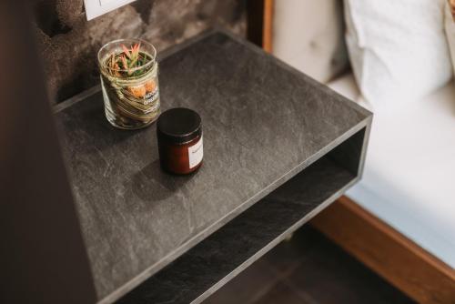a table with a jar of spices on it at Stari Toranj V studio apartman in Vukovar