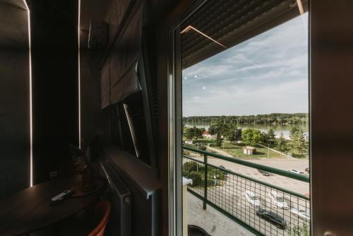a window in a room with a view of a river at Stari Toranj V studio apartman in Vukovar