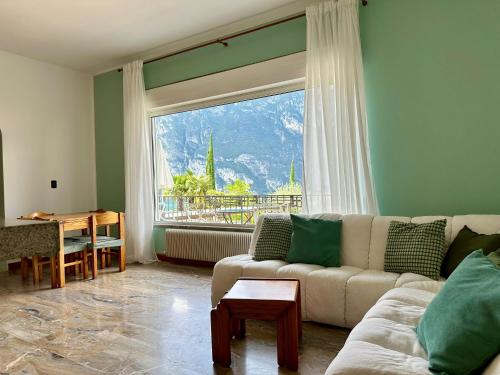 a living room with a couch and a large window at The Queen of Garda in Riva del Garda