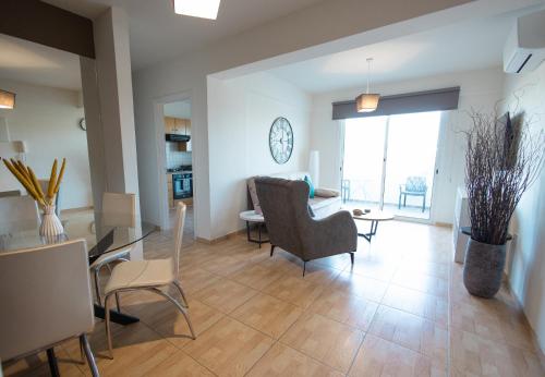 a living room with a table and chairs at Maestro III Apartment in Larnaca