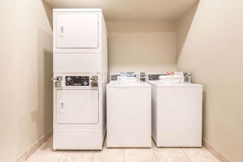 three white washers andifts in a small room at Ramada by Wyndham College Station in College Station