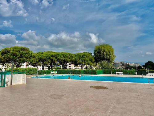 - une grande piscine avec des personnes dans l'établissement Les Masters YourHostHelper, à Mandelieu-la-Napoule