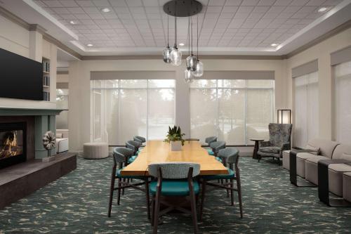a conference room with a table and chairs and a fireplace at Hilton Garden Inn Columbia/Harbison in Columbia