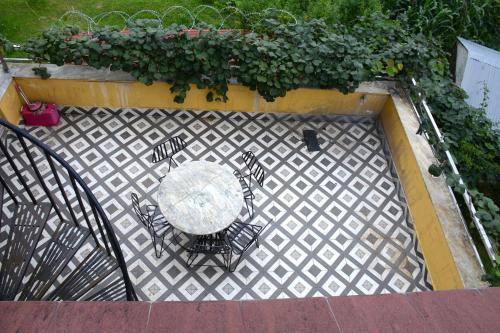 an overhead view of a table and chairs on a patio at Beautiful house and garden in Kathmandu