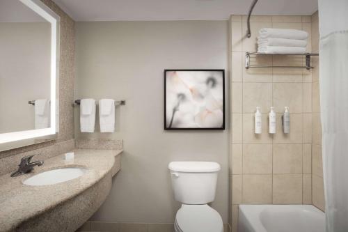 a bathroom with a toilet and a sink and a shower at Hilton Garden Inn Columbia/Harbison in Columbia