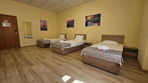a room with three beds in a room at Hostel CANTO in Ruse