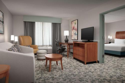 a hotel room with a couch and a television at Hilton Garden Inn Columbia/Harbison in Columbia