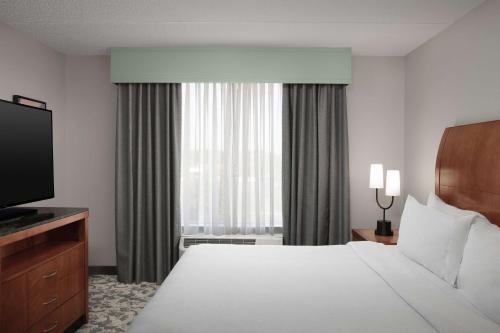a hotel room with a bed and a television at Hilton Garden Inn Columbia/Harbison in Columbia