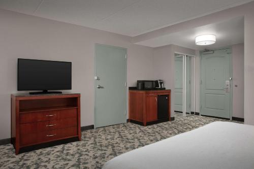 a room with a flat screen tv on a dresser at Hilton Garden Inn Columbia/Harbison in Columbia