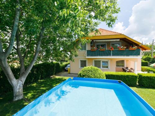 a house with a swimming pool in front of a house at Holiday Home Pentaller by Interhome in Balatonföldvár