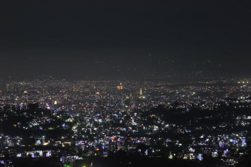 a view of a city at night at Beautiful house and garden in Kathmandu
